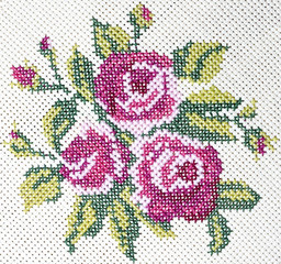 Old cross stitch embroidery of rose and leaves