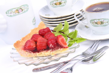 Strawberry tart, mint twig and a cup of tea