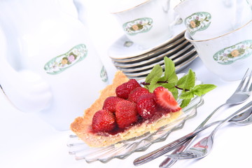 Strawberry tart, mint twig and tableware