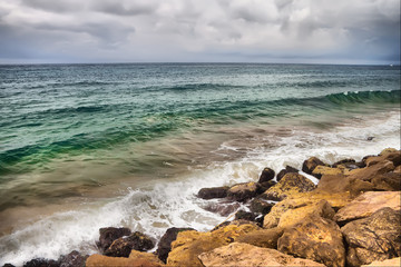 Fototapeta na wymiar stones in surf waves.