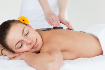 Obraz na płótnie Canvas Close up of a woman enjoying a hot stone massage