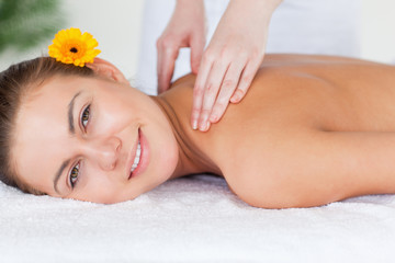 Obraz na płótnie Canvas Close up of a beautiful woman having a shoulder massage