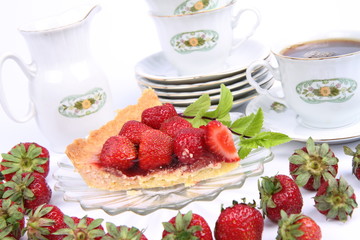 Strawberry tart, mint twig and a cup of tea