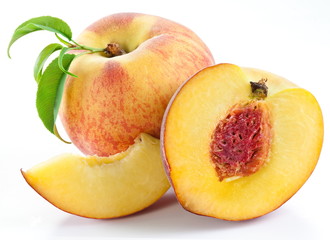 Naklejka na ściany i meble Ripe peach fruit with leaves and slises