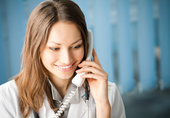 Portrait of happy smiling cheerful young female doctor