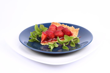 Piece of Strawberry Tart decorated with mint twigs
