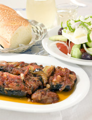Greek stuffed eggplant and Greek salad crusty bread wine