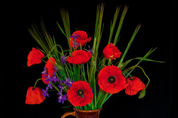 Bunch of red poppies and corn