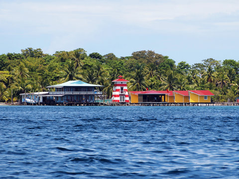 Bungalows, house and a lighthouse on the sea shore of a tropical Caribbean island, Bocas del toro, Panama, Central America