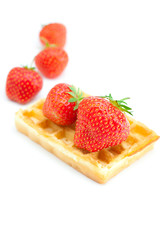 Waffles and strawberries isolated on white