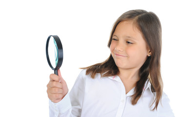 girl looking through a magnifying glass