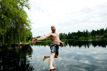 Man jumping in a lake