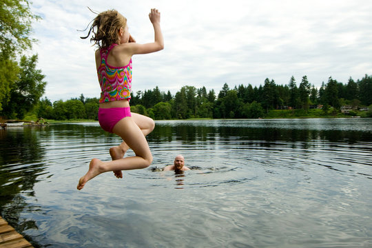 child jumping in a lake