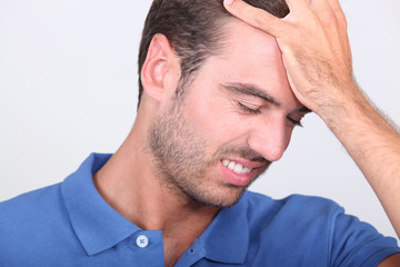 Fototapeta premium a 35 years old man taking his head with his hand
