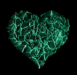 broken green glass heart isolated on black background.