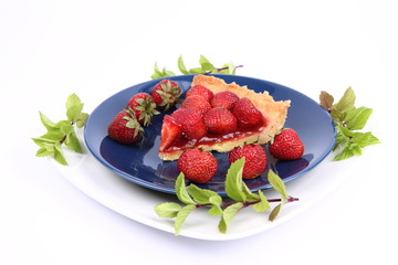 Piece of Strawberry Tart decorated with strawberries and mint