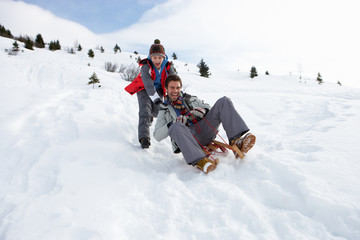 Young Father And Son Sledding - obrazy, fototapety, plakaty