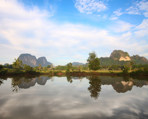 Fototapeta na wymiar Rocks hills and mountains with reflection in the water. Krabi province of Thailand