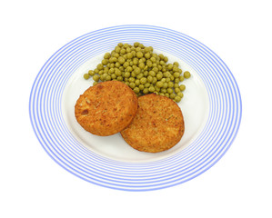 Fish cakes and peas on plate