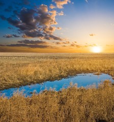 blue lake in a steppe at the evening
