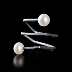 Ring with pearls on black background