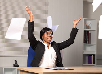 Happy beautiful business woman throws paper in air