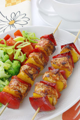 Chicken skewers and french fries