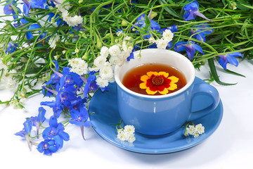 The blue cup of tea with nice flowers