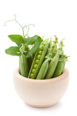 Green peas in a wooden bowl