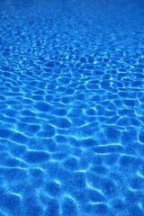 Fototapeta na wymiar blue tiles swimming pool water reflection texture