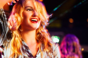 Naklejka premium Woman in club or bar having fun (motion blur!)