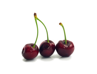 three ripe dark red cherries