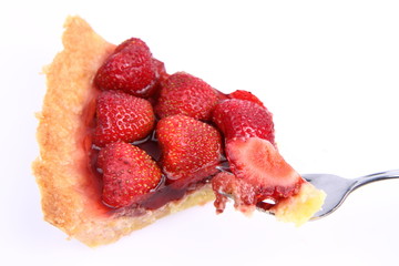 Strawberry Tart portion, a bite on a fork, on a white