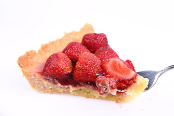 Strawberry Tart portion, a bite on a fork, on a white