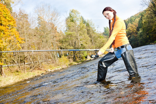 woman fishing in Otava river, Czech Republic