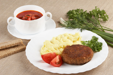 Cutlet with mashed potatoes and soup