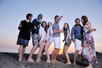 Group of young people enjoy summer  party at the beach