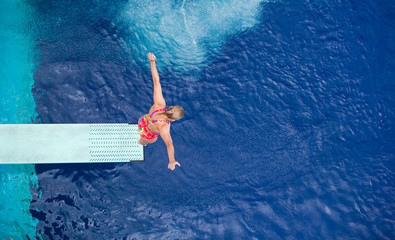 preparing to dive into a swimming pool