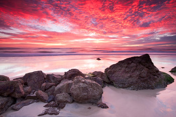 australian seascape at sunrise with rich in red color