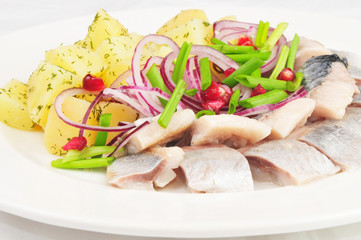 Boiled potato with a herring