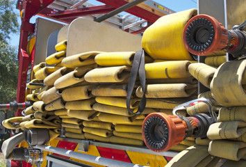 Up close view of a yellow fire hose on a firetruck