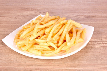 tasty potatoes in a bowl on wooden background