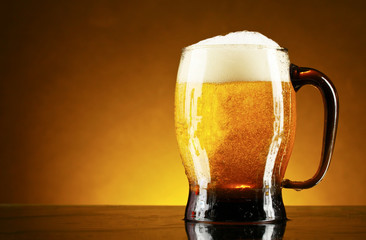 mug of beer on a yellow background