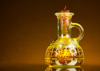 jar of oil on a yellow background