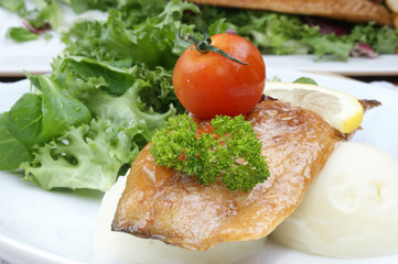 Fototapeta na wymiar smoked mackerel fillet with tomato on mash potato
