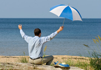 happy man with umbrella  on seacoast