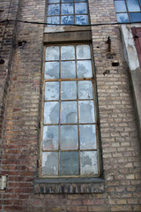 the very old window on the brick wall