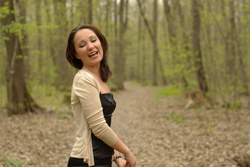 Laughing girl in the spring forest