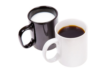 Black cup with milk and a white cup with black coffee.