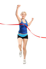 Female runner running towards a finish line